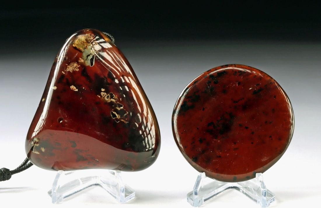 Indonesian Large Amber Pendant & Polished Disc: Southeast Asia, Indonesia, Sumatra, ca. late 20th to 21st century CE. A wearable oversized amber pendant strung on a cord, accompanied by a polished amber disc. Formed from ancient tree resin that har