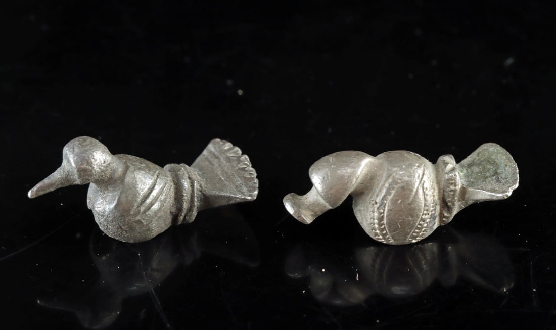 Pair Ancient Celtic Silver Zoomorphic Bird Appliques: Central Europe, Celtic culture, ca. 400–100 BCE. A pair of cast silver zoomorphic appliques, each modeled as a perched bird with spread tail and globular body with beaded and incised decoration 