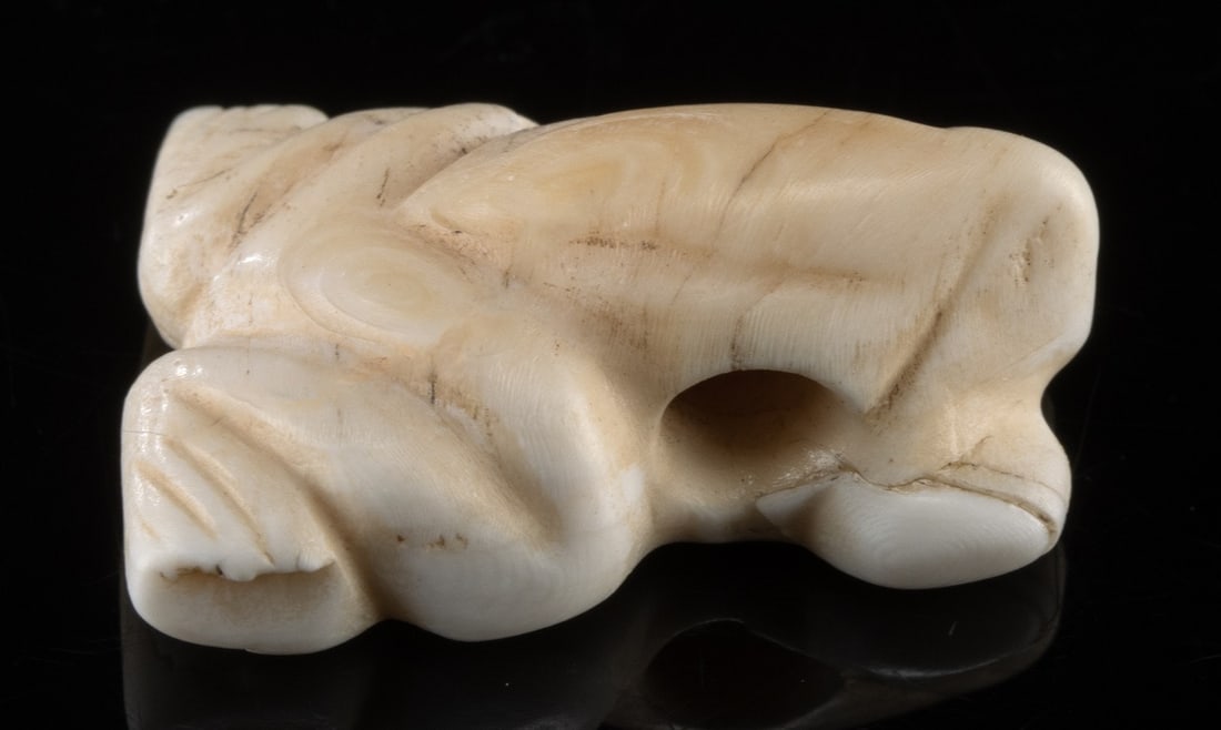Mesopotamian Shell Frog Charm, evaluated by W. Lambert: Ancient Near East, Mesopotamia / Syria, ca. 3000 to 500 BCE. A charming frog charm carved from white shell, with a suspension hole pierced through the body. Accompanying the piece is a typewritten des
