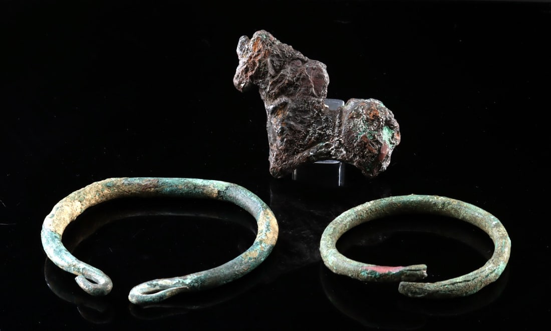 Two Ancient Bronze Age Cuff Bracelets & Horse Figurine: Central Europe or Near East, ca. late Bronze to early Iron Age, 1000 to 200 BCE. Two bronze cuff bracelets, each formed from thick circular rods bent into open loops, the terminals gently curved inwar