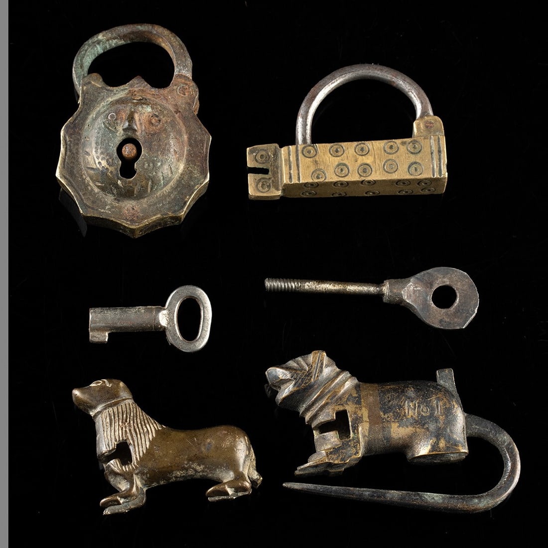 19th C. Persian & Indian Brass Padlocks - Lion & Target Motifs, Group of 4: Middle East, Persia, Qajar Dynasty; South Asia, India, ca. 1800–1899 CE. A quartet of hand-forged brass padlocks that blend security with sculptural whimsy. Three are Persian work of the Qajar e
