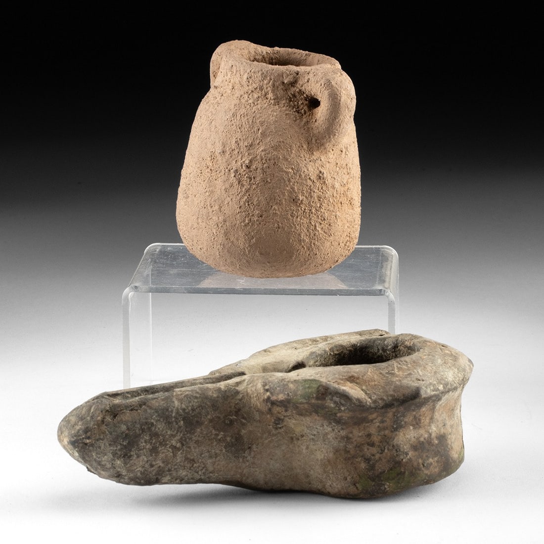 Holy Land Pottery Pair - Levantine Lug-Handled Jar & Islamic Oil Lamp: Eastern Mediterranean, Holy Land, ca. 100 BCE; Near East, Islamic period, ca. 8th to 9th century CE. A pairing of utilitarian earthenware spanning nearly a millennium of life in the Levant. The first,