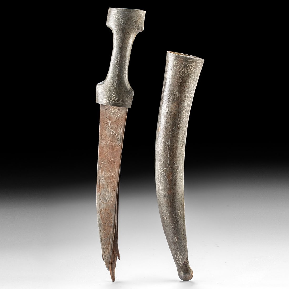 19th C. Persian Steel Zulfiqar Dagger & Sheath - Silver Inlay: Western Asia, Persia, Qajar, ca. 1800–1899 CE. A curved steel dagger whose blade divides along its axis into twin points, the cleft tip that identifies it as a Zulfiqar, forged after the legenda