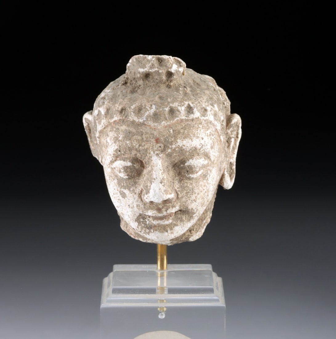 Gandharan Stucco Buddha Head - Serene Hellenistic-Influenced Features: Central Asia, Pakistan / India, Gandhara / Kushan, ca. 100 BCE – 400 CE. A finely modeled stucco head of the Buddha in meditative repose, the face displaying the classical Gandharan synthesis of