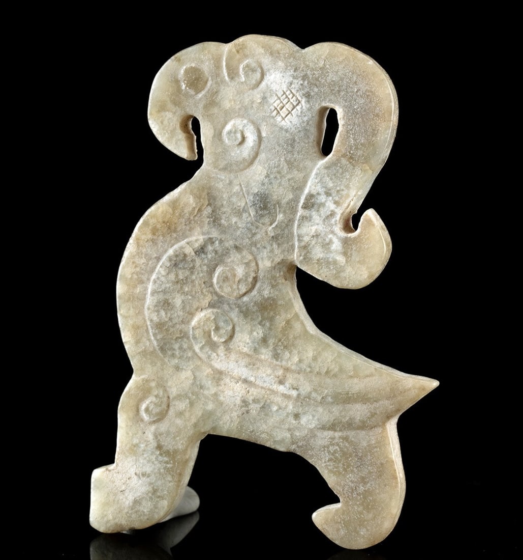 Chinese Qing Nephrite Jade Carving Fenghuang / Phoenix: East Asia, China, Qing Dynasty, ca. 19th to early 20th century CE. A delightful nephrite jade carving of a mythical bird known as a fenghuang or phoenix. A long curvilinear crest extends from the top 