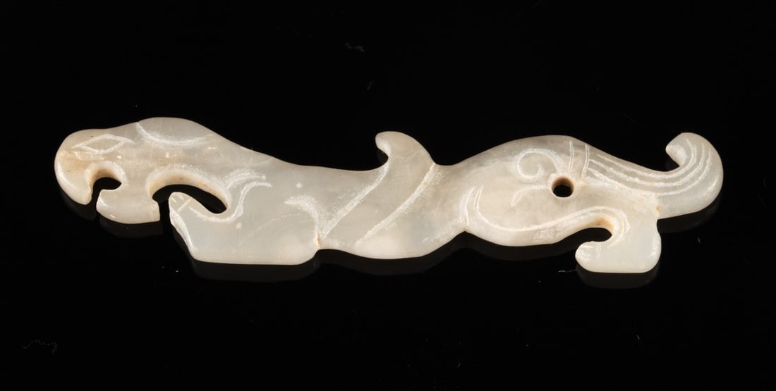 Chinese White Jade Archaic Style Tiger Pendant: East Asia, China, ca. mid-20th century CE. A white jade pendant carved as a sinuous tiger-feline in an archaic style, with curled limbs, a raised spine, and incised scroll motifs that echo early ritua