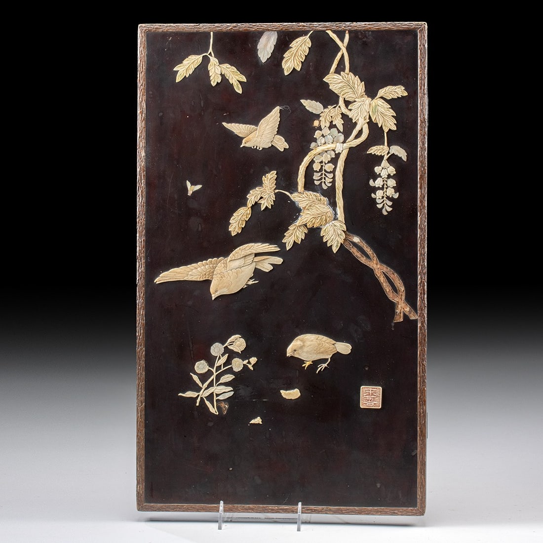 Meiji Ivory Inlaid Wood Panel - Songbirds & Wisteria: Japan, Meiji period, ca. late 19th to early 20th century CE. This refined Shibayama-inlaid wood panel is intricately decorated with ivory on a black lacquer ground, depicting three songbirds amidst bl