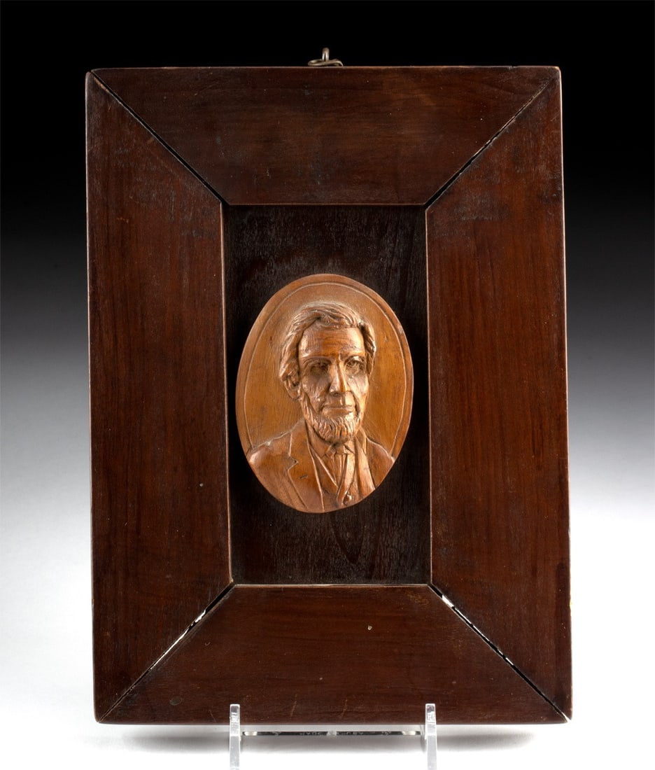 19th C. American Carved Wood Lincoln Relief Portrait: North America, United States, American folk art, ca. 1861–1875 CE. A carved wooden medallion holds the sixteenth president in low relief, his bearded face turned three-quarters into the light, t