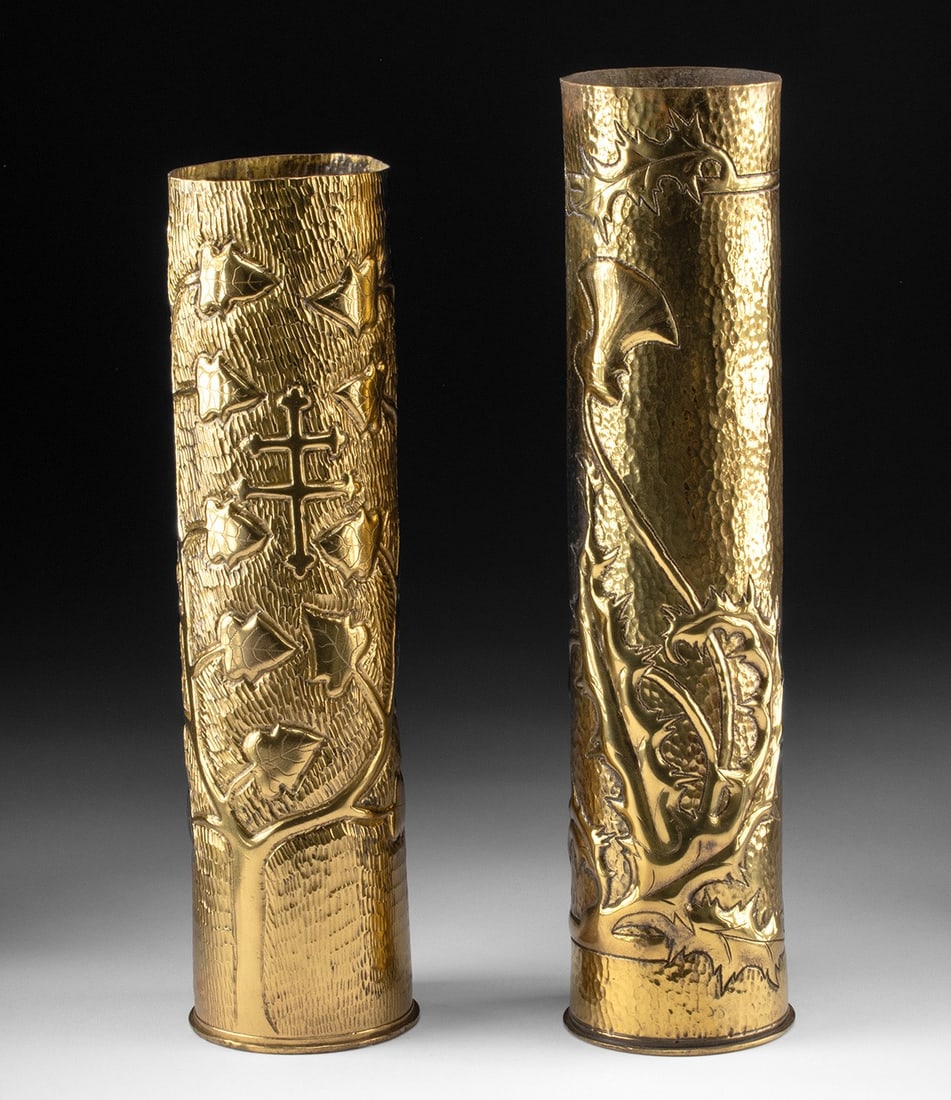 WWII Carved Mortar Shells: Thistle & Cross of Lorraine: Western Europe, Post-WWII era, ca. 1940s to 1950s CE. A pair of brass mortar shells repurposed as sculptural vases, reflecting wartime transformation of military material into symbolic objects. One ex