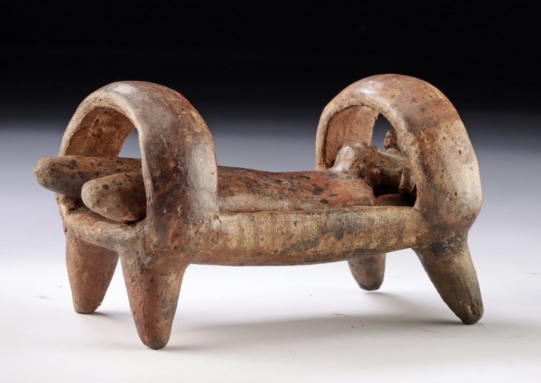 Rare Nayarit Terracotta Bedded Figure, Two-Part Ensemble: Ca. 1 - 50 CE. Pre-Columbian, West Mexico, Nayarit. Wonderful and quite rare bedded figure created in 2 parts. First, a shallow bed on 4 conical legs with 2 wide supports designed to go over the head 