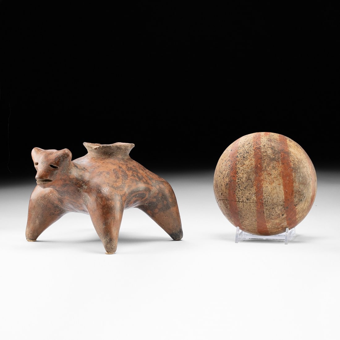 Jalisco Redware Pottery Dog Effigy Vessel & Bowl: Pre-Columbian, Mexico, Jalisco, ca. 300 BCE – 300 CE. A pair of burnished redware ceramics from the shaft-tomb cultures of West Mexico. The larger is an effigy vessel modeled as a plump, short-l