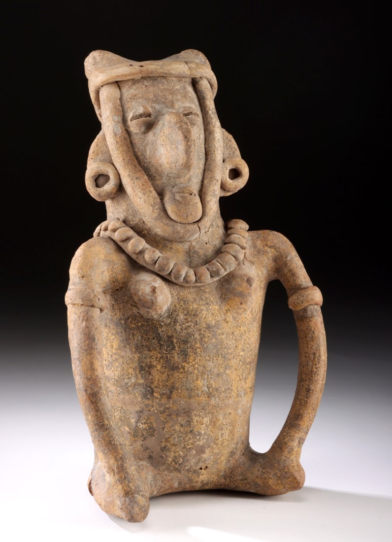 Nayarit Seated Figure Nude Female w/ Bird-Like Visage: Pre-Columbian, West Mexico, Nayarit, ca. 300 BCE to 300 CE. An impressive pottery figure of a nude female seated with a stylized, bird-like visage of bulging, round eyes, a huge, beak-like nose, and a