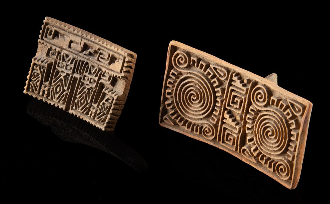 Pair Aztec Pottery Body Stamps (Sellos), ex-Lands Beyond: Ca. 1300 - 1350 CE. Pre-Columbian, Mexico, Aztec. A pair of Aztec fired clay stamps, each presenting a densely carved rectangular face with a raised handle on the reverse, one decorated with a bold co