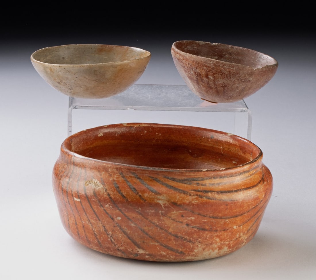 Group of 3 West Mexican Nayarit Pottery Bowls: Ca. 1 - 50 CE. Pre-Columbian, West Mexico, Nayarit. Three pottery bowls dating 2000 years old. The largest and most extensively decorated was painted with black lines against an orange background on t