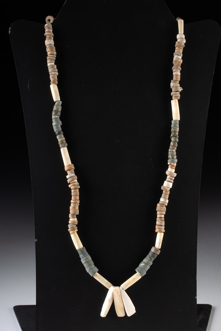 Colombian Shell Necklace: Pre-Colombian, —--, ca. 800 - 1200 CE. A collection of ancient stone and shell beads strung together as a wearable necklace on a modern string. The necklace combines disc-shaped stone beads with