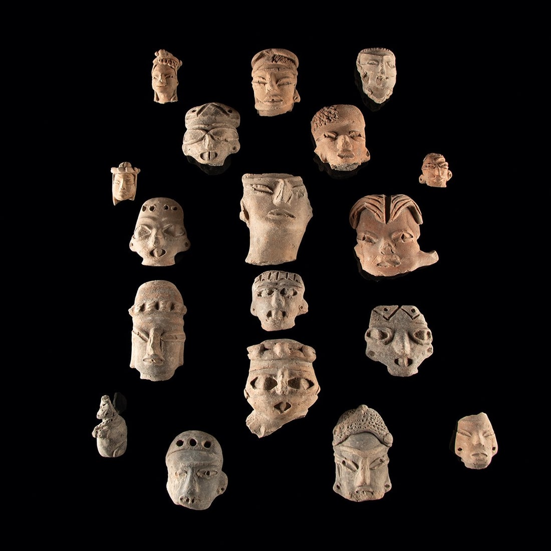 Pre-Columbian Mexico Pottery Figural Head Fragment Group of 18: Pre-Columbian, Mexico, ca. 300 BCE – 1500 CE. A group of Pre-Columbian pottery head fragments from Mesoamerica, most likely Central Mexico, dating primarily to the Preclassic through Classic per