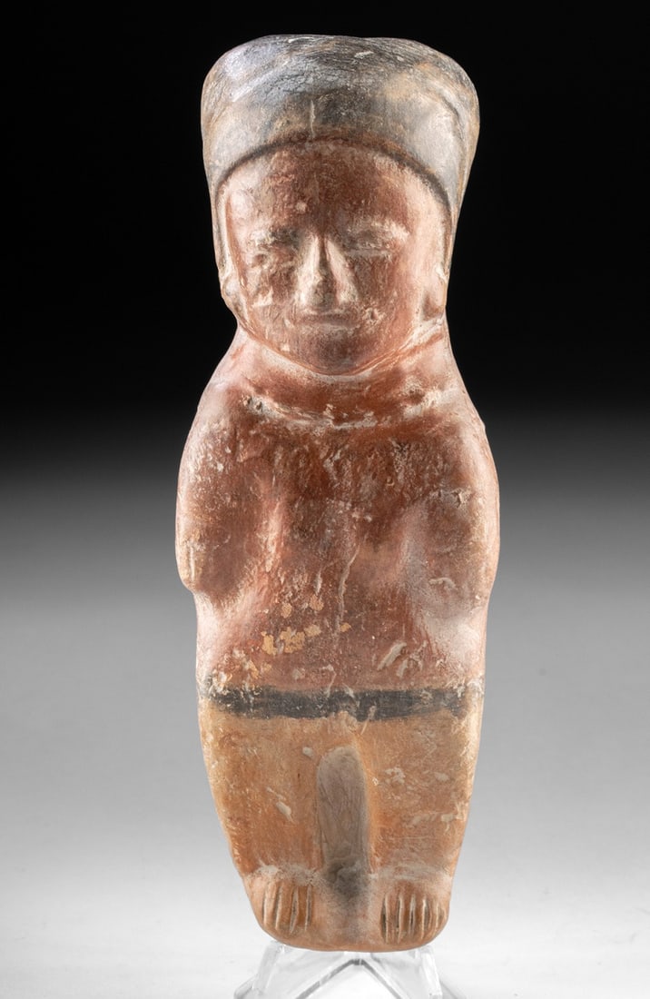 Manabi Bahia Polychrome Female Figural Whistle: Pre-Columbian, Ecuador, Manabi Province, Bahia culture, ca. 300 BCE to 800 CE. A hand-modeled terracotta female figural whistle of the Bahia culture, the columnar body finished in warm red slip above 