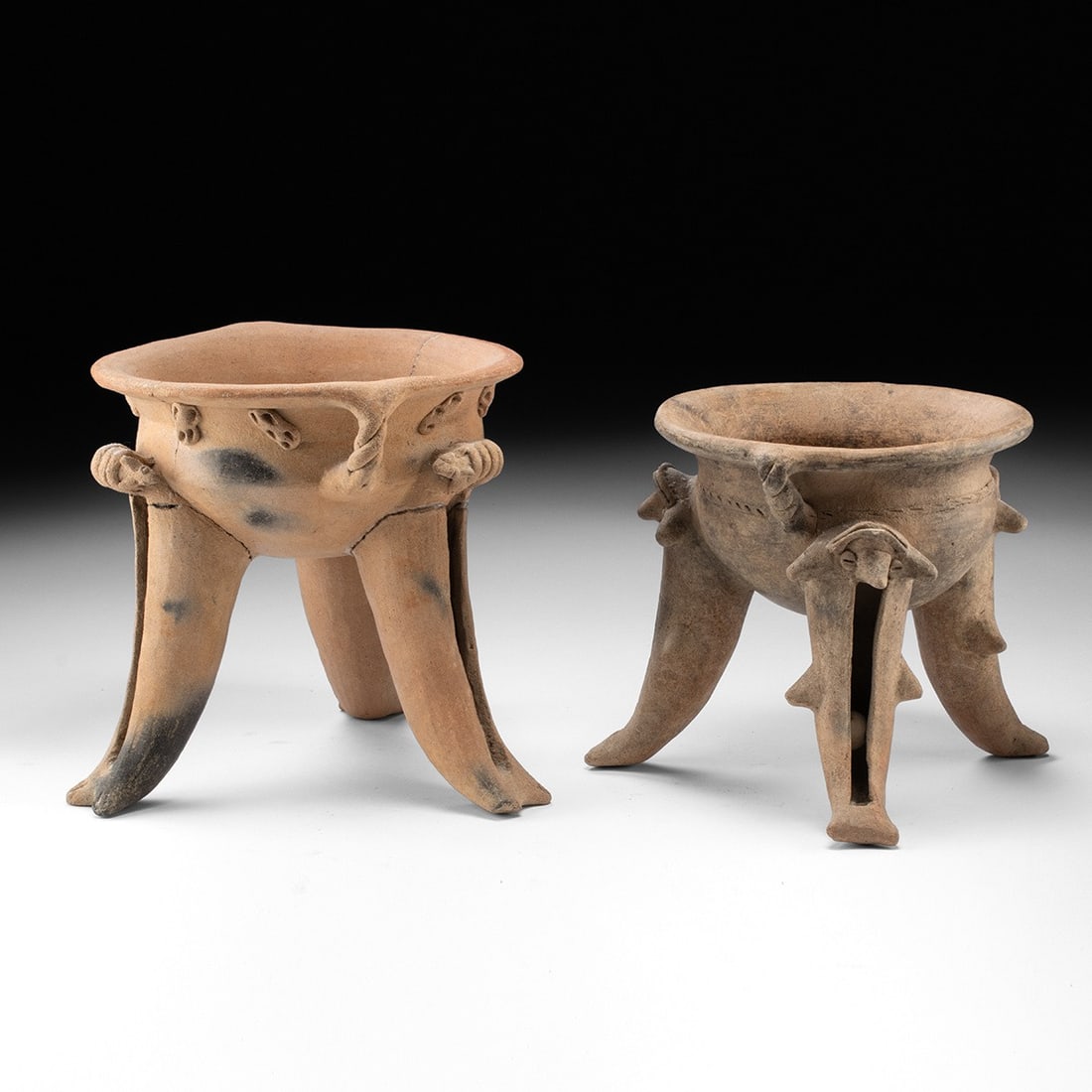 Two Ancient Costa Rican Terracotta Tripod Rattle Bowls - Zoomorphic Supports: Pre-Columbian, Costa Rica, Guanacaste-Nicoya, ca. 300–800 CE. A pair of pottery tripod rattle bowls, each raised on three hollow zoomorphic supports containing clay pellets that sound when the v
