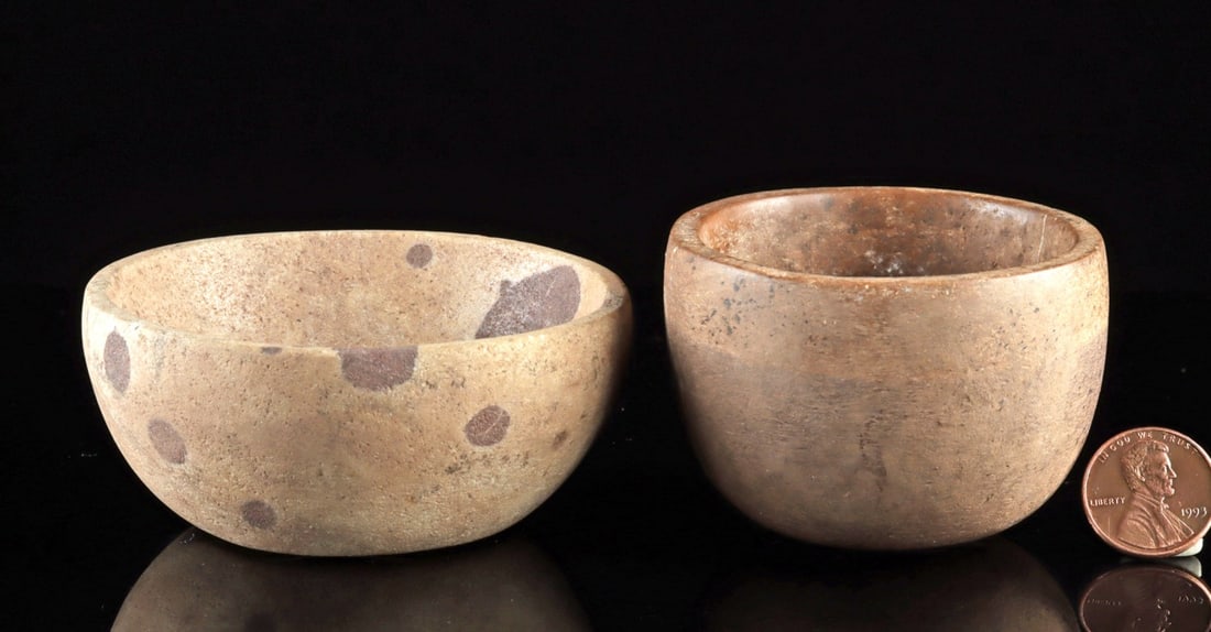 Pair of Miniature Chontal Stone Bowls or Mortars: Pre-Columbian, Mesoamerica, Mexico, Chontal culture, ca. 500 BCE to 500 CE. A modest and appealing lot of two miniature Chontal stone bowls or mortars, carved from dense stone with rounded profiles an