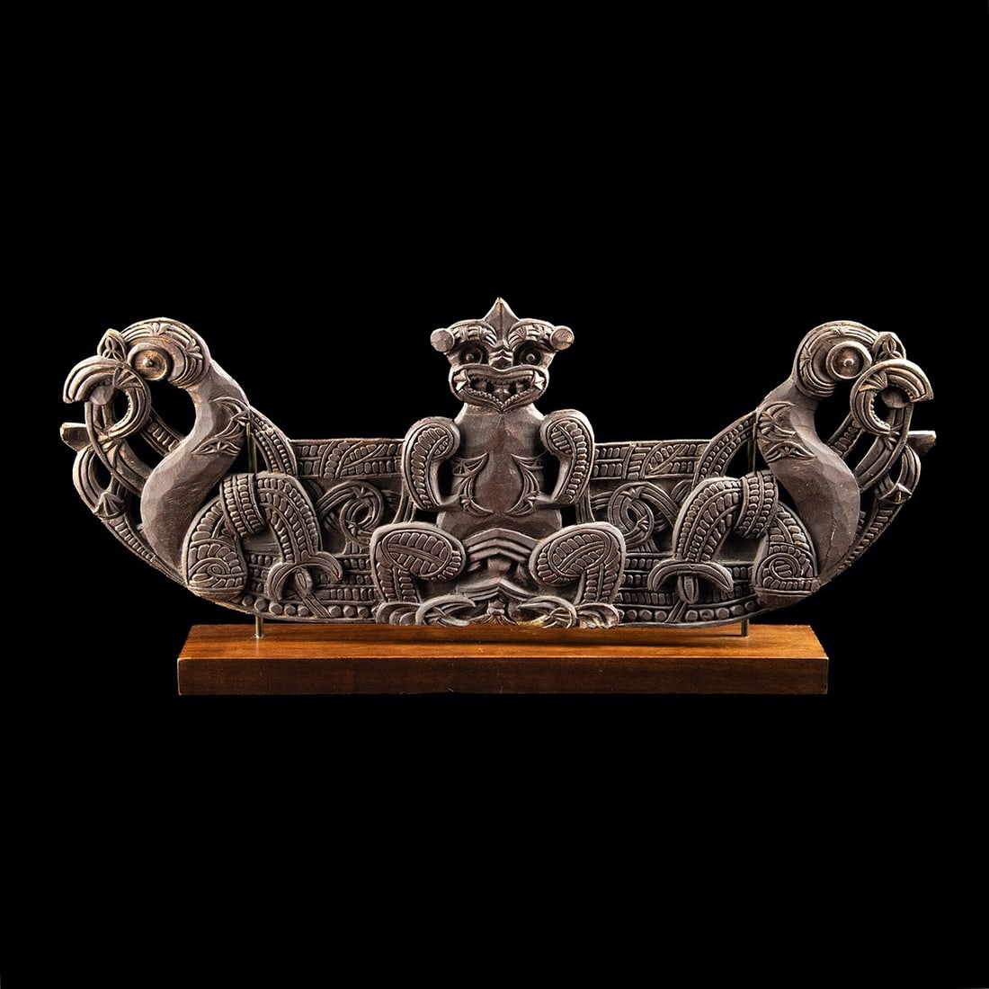 19th C. Maori Carved Wood Pare Lintel - Ancestor & Manaia: Oceania, New Zealand, Maori, ca. 1800–1920 CE. A dense field of interlocking spirals and notched relief resolves into a commanding central figure, a female ancestor with protruding tongue, spira
