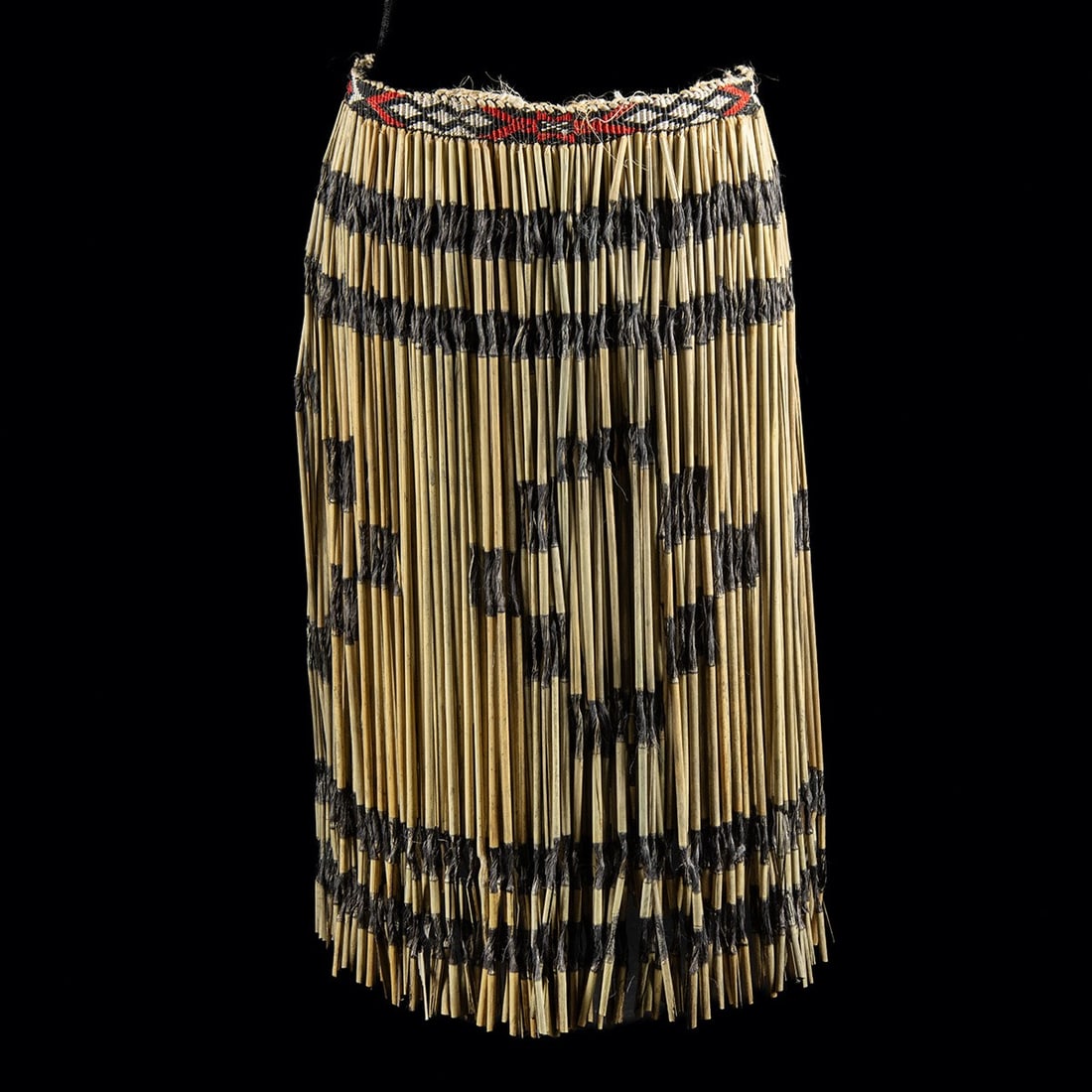Mid-20th C. Maori Flax Piupiu Dance Skirt - Geometric Dyed Bands: Oceania, New Zealand, Maori, ca. 1950–1959 CE. A traditional piupiu dance skirt constructed of prepared flax (harakeke, Phormium tenax) leaves rolled into cylindrical strands. Sections of each s