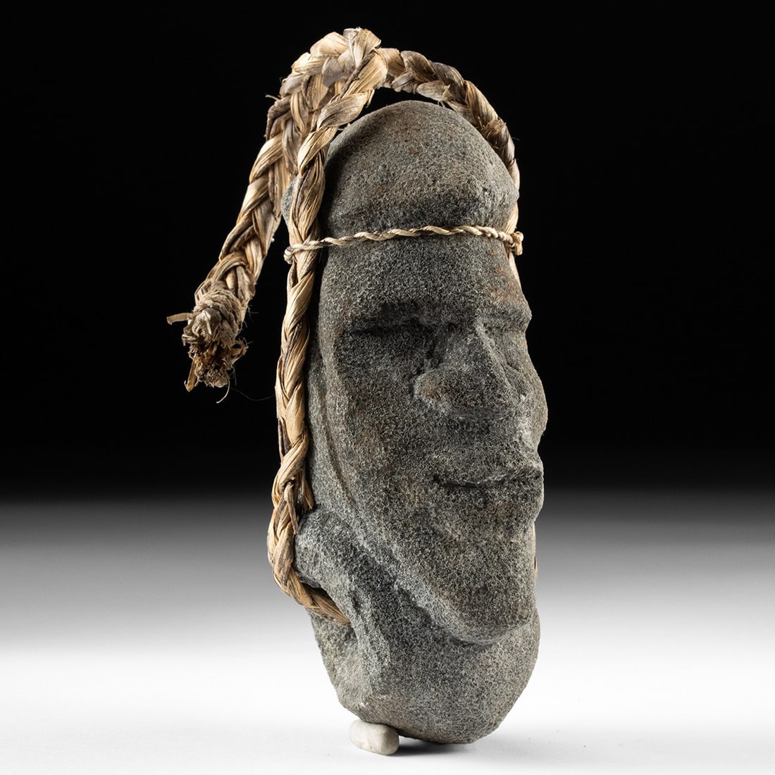 Solomon Islands Carved Coral - Ancestor Figure: Oceania, Melanesia, Solomon Islands, ca. 1850–1950 CE. An ancestor head worked from a single mass of coral, the face carved in bold relief on an elongated, gently tapering form. A heavy domed cr