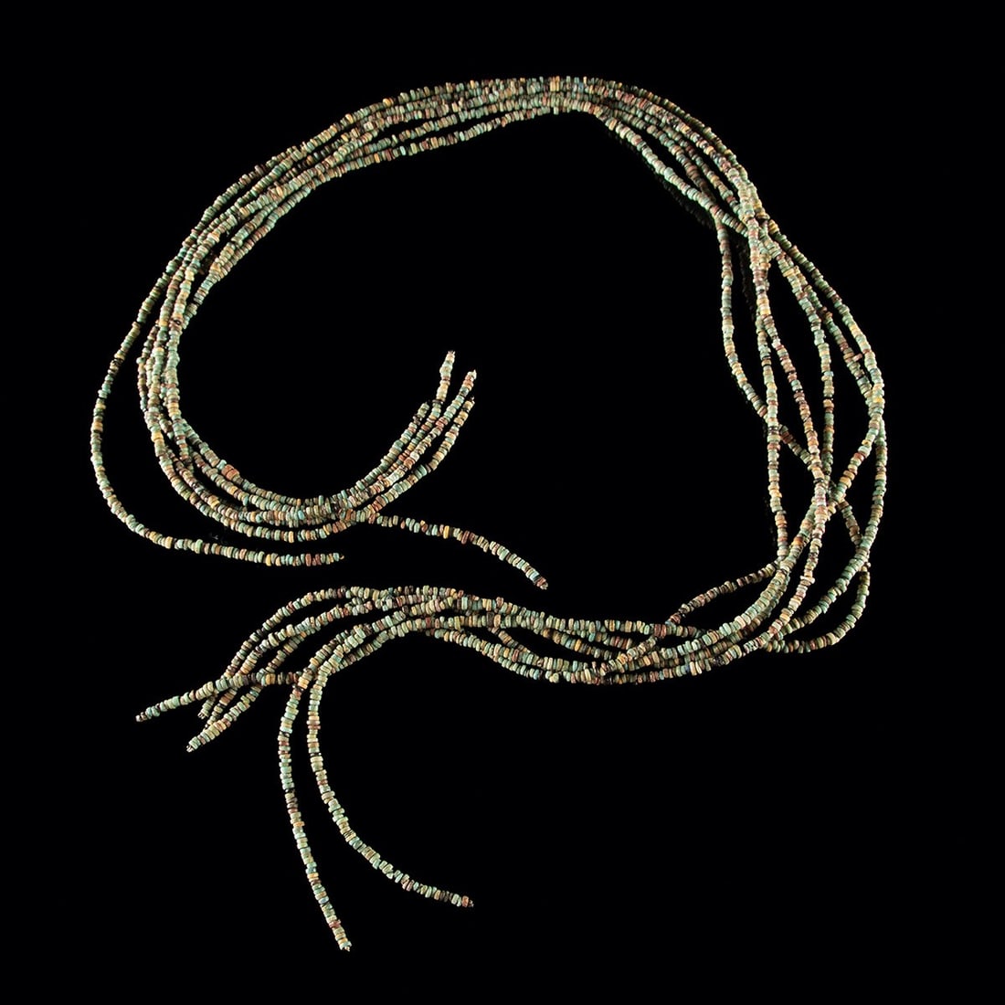 Ancient Egyptian Faience Beads, Six Lengthy Strands: Egypt, New Kingdom to Late Period, ca. 1550–332 BCE. A collection of ten equal-length strands of tiny faience seed beads, likely originally part of a multi-strand necklace. The beads have been r