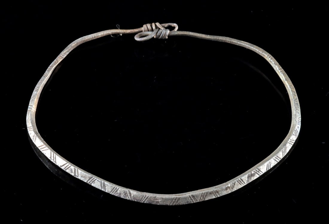 Thracian Silver Torque Bracelet, Geometric Design: Ancient Greece, Thrace, ca. 4th to 3rd century BCE. Thracian silver torque bracelet of rounded form, hammered and engraved with a continuous band of incised diagonal and cross-hatched motifs forming a