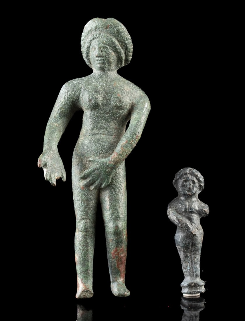 Two Roman Bronze Nude Venus Figurines - Pudica Type: Roman, Imperial period, ca. 1st to 3rd century CE. A compelling pair of intimate devotional figures, these two Roman statuettes depict Venus in her timeless Pudica pose, modest yet unmistakably sensua