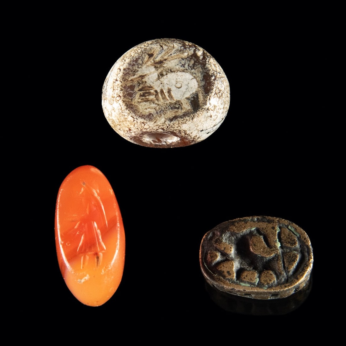 3 Sassanian Stamp Seals (Carnelian, Red Jasper, Bronze): Ancient near-east, Sassanian Empire, Iran/Iraq, ca 500 CE. Trio of stamp seals in carnelian, red jasper and bronze. Stamp seals were used continuously in the near-east from about 3000 BCE to 800 CE as