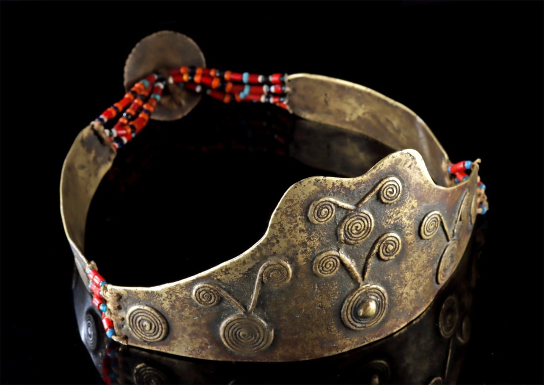 Naga Brass & Beaded Ceremonial Crown Diadem: South Asia, Northeast India, Naga people, ca. 20th century CE. An impressive ceremonial crown of hammered brass, formed into a broad band that rises to a scalloped peak at the front. The surface is ri