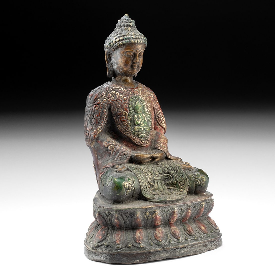 19th C. Tibetan Painted Brass Buddha - Sealed Consecrated Figure: Central Asia, Tibet, ca. 1850–1950 CE. A serene brass Buddha seated in the meditative padmasana atop a lobed double lotus throne, hands folded in dhyana mudra, the gesture of profound contemplat