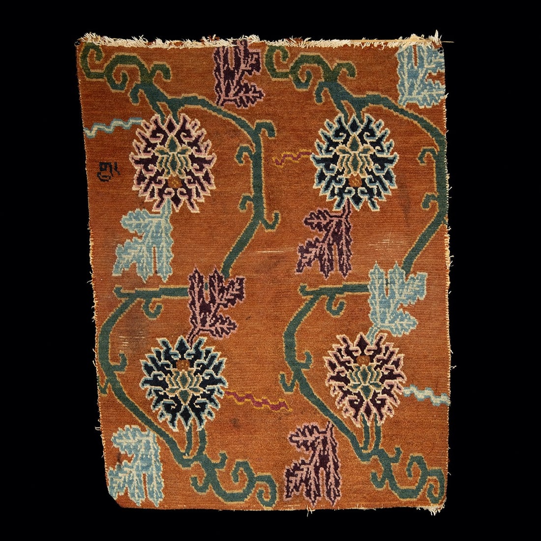 19th C. Tibetan Wool Khaden Rug - Floral Medallions & Scrolling Vines: Central Asia, Tibet, ca. 1880–1930 CE. A hand-knotted wool khaden, the small rug used for sleeping and sitting in domestic life across the Tibetan plateau. The rust-brown field is decorated with