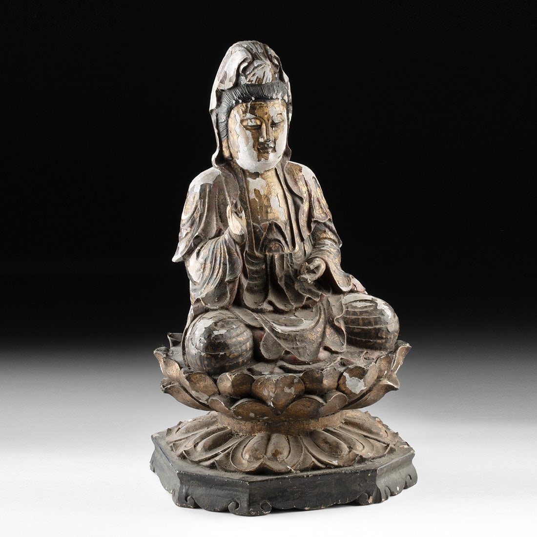 Qing Dynasty Carved Wood Guanyin - Gilt Polychrome Bodhisattva on Lotus: East Asia, China, Qing Dynasty, ca. 19th to early 20th century CE. A serene wood figure of Guanyin in meditative repose atop a double-tiered lotus throne. The bodhisattva sits in dhyanasana on a lotus