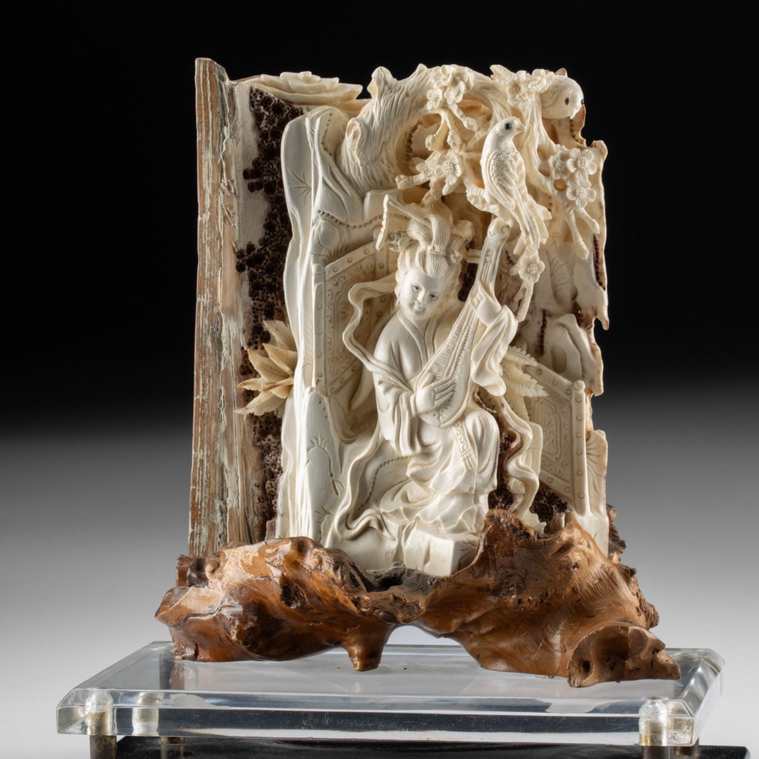 20th C. Chinese Mammoth Ivory Carving - Woman Playing Pipa: East Asia, China, late Qing Dynasty to Republic period, ca. 1880–1940 CE. A relief carved from a section of fossil mammoth ivory, the natural bark of the tusk left rough along one edge to frame 
