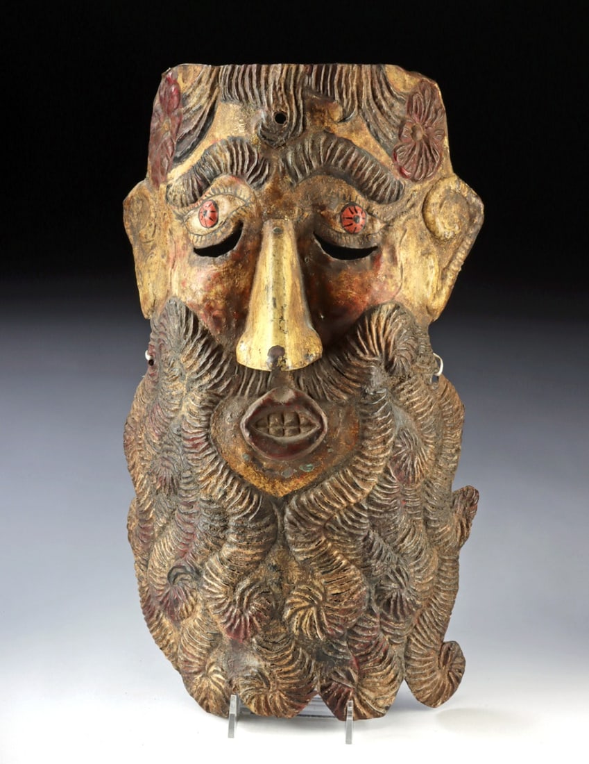 Mexican Guerrero Copper Mask - Barbone w/ Flowers: Latin America, Mexico, Guerrero, ca. mid-20th century CE. A bold and enigmatic Barbon mask, its commanding face framed by a luxuriant, deeply carved beard and animated by striking pink eyes that lend 
