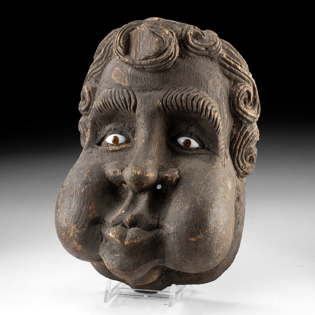19th C. Guerrero Wood Dance Mask - Wind Spirit with Glass Eyes: North America, Mexico, Guerrero, Mestizo folk tradition, ca. 1870–1950 CE. A round face caught mid-breath, both cheeks swollen to their limit, the lips pursed tight at the center. Carved from a 