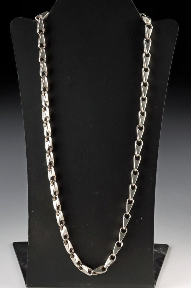 Mexican Silver Chain Link Necklace: North America, Mexico, ca. 20th century CE. A refined silver chain link necklace composed of elongated sculptural links crafted from high-grade silver measuring approximately 95.6% purity. Each polish