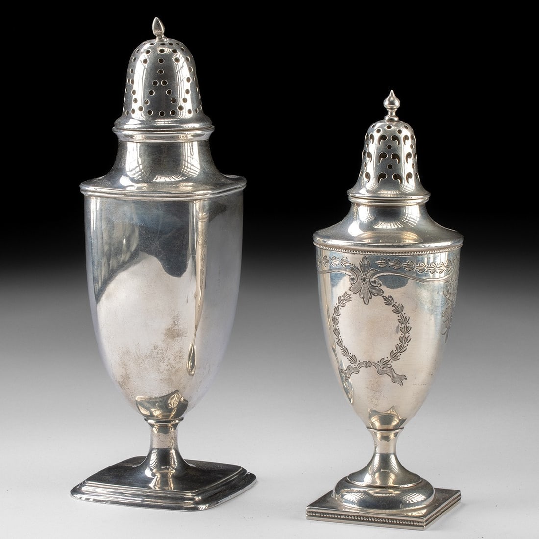 Early 20th C. Silver Muffineers - Towle & Birks, Square Bases: North America, United States, Massachusetts, Newburyport, Towle; Canada, Henry Birks & Sons, ca. 1880–1950 CE. A pair of urn-form muffineers, or sugar casters, rising on slender stems from stepp