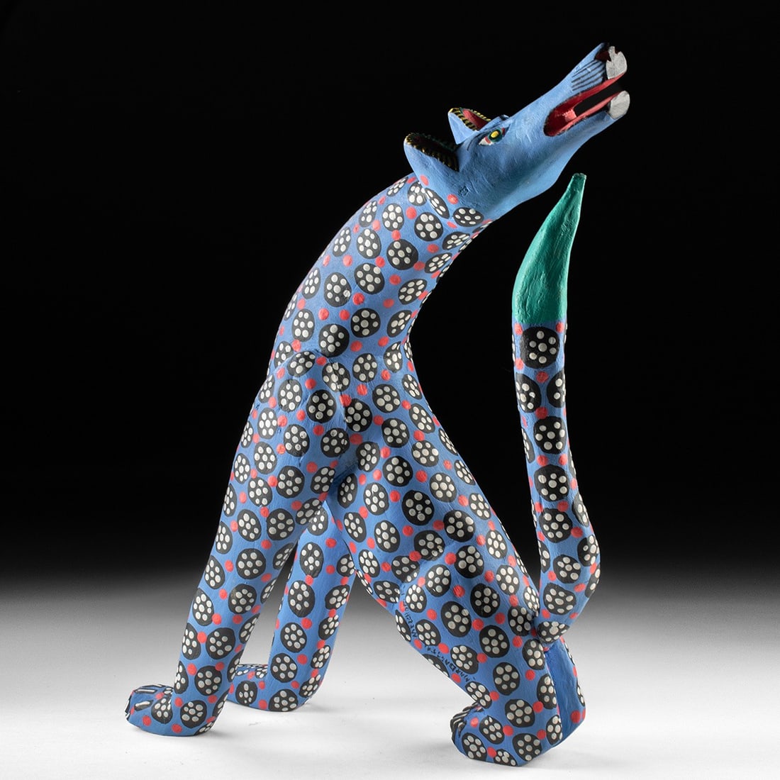 Large Mexican Folk Art Alebrije - Howling Coyote by Margarito Melchor Fuentes: Mexico, ca. late 20th to early 21st century CE. A large vintage Oaxacan wood alebrije of a howling coyote by Margarito Melchor Fuentes of San Martin Tilcajete, signed along the haunch. The coyote is c