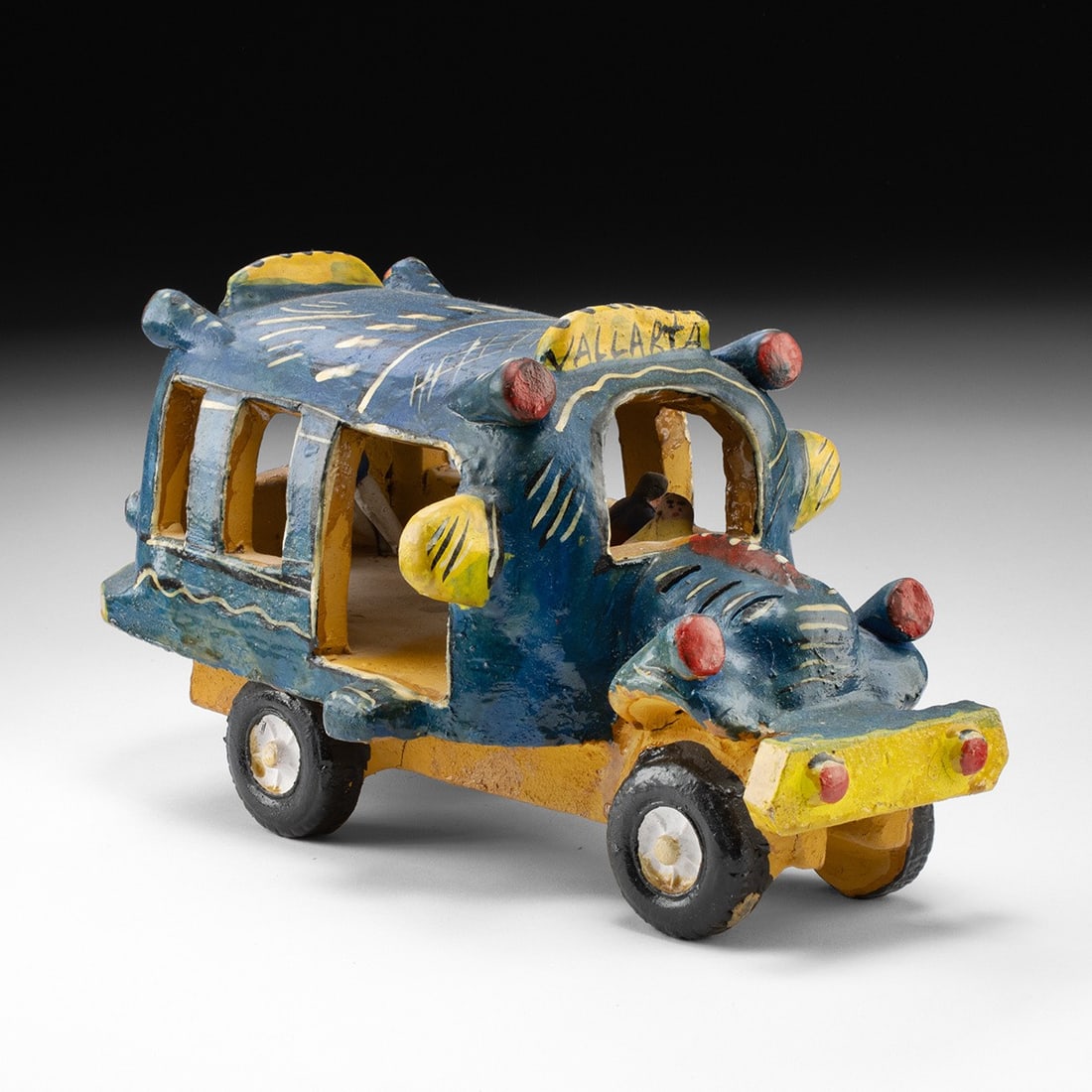 Mexican Polychrome Ceramic Bus - Attr. Candelario Medrano: Mexico, Jalisco, Santa Cruz de las Huertas, ca. mid-20th century CE. A polychrome ceramic bus attributed to Candelario Medrano of Santa Cruz de las Huertas, Jalisco. The hand-modeled vehicle is painte