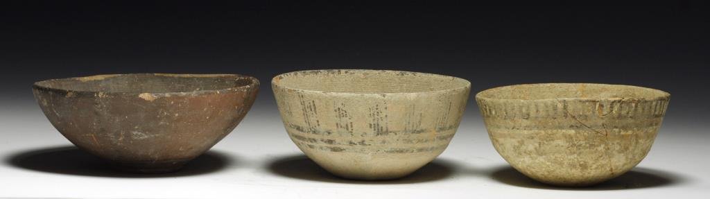 Lot of 3 Indus Valley Shallow Bowls: Starts at $100 Indus Valley, ca. 4000 BCE. A set of three terracotta bowls, each decorated with linear designs. Two bowls with white slips, the other with a dark brown slip. 3-7/8"D - 5"D. Provenance: