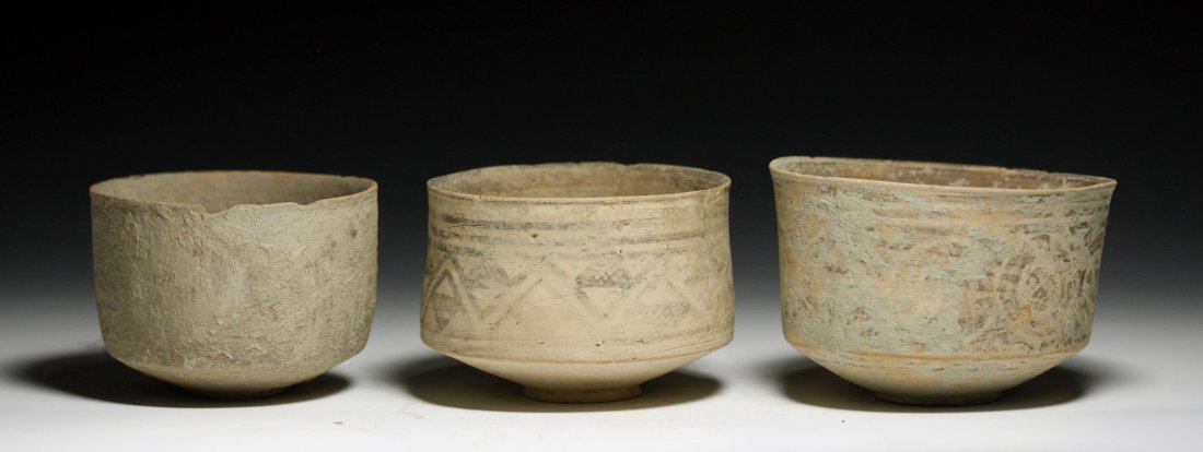 Lot of 3 Indus Valley Shallow Bowls: Starts at $100 Indus Valley, ca. 4000 BCE. A set of three terracotta bowls, each decorated with linear designs. Two bowls with white slips, the other with a dark brown slip. 3-7/8"D - 5"D. Provenance: