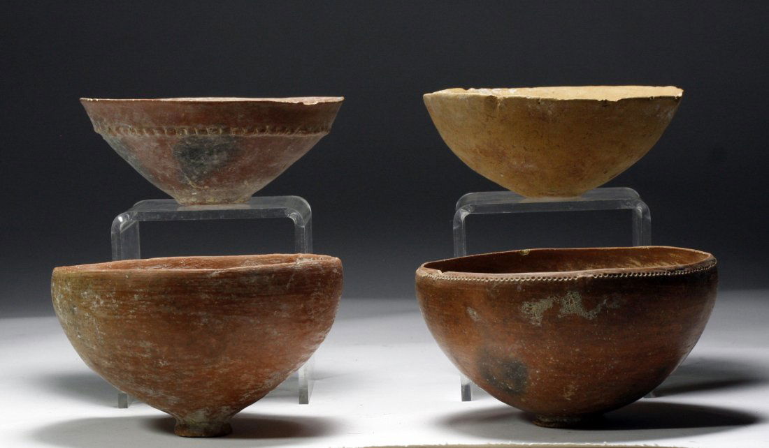 Lot of 4 Iron Age Holyland Terracotta Bowls: Starts at $200 Holy Land, Iron Age, ca. 1300 -1000 BCE. Four terracotta redware bowls of varying shape and detail. Bowl 1: Light red - orange bowl with raised center and three sets of linear markings.