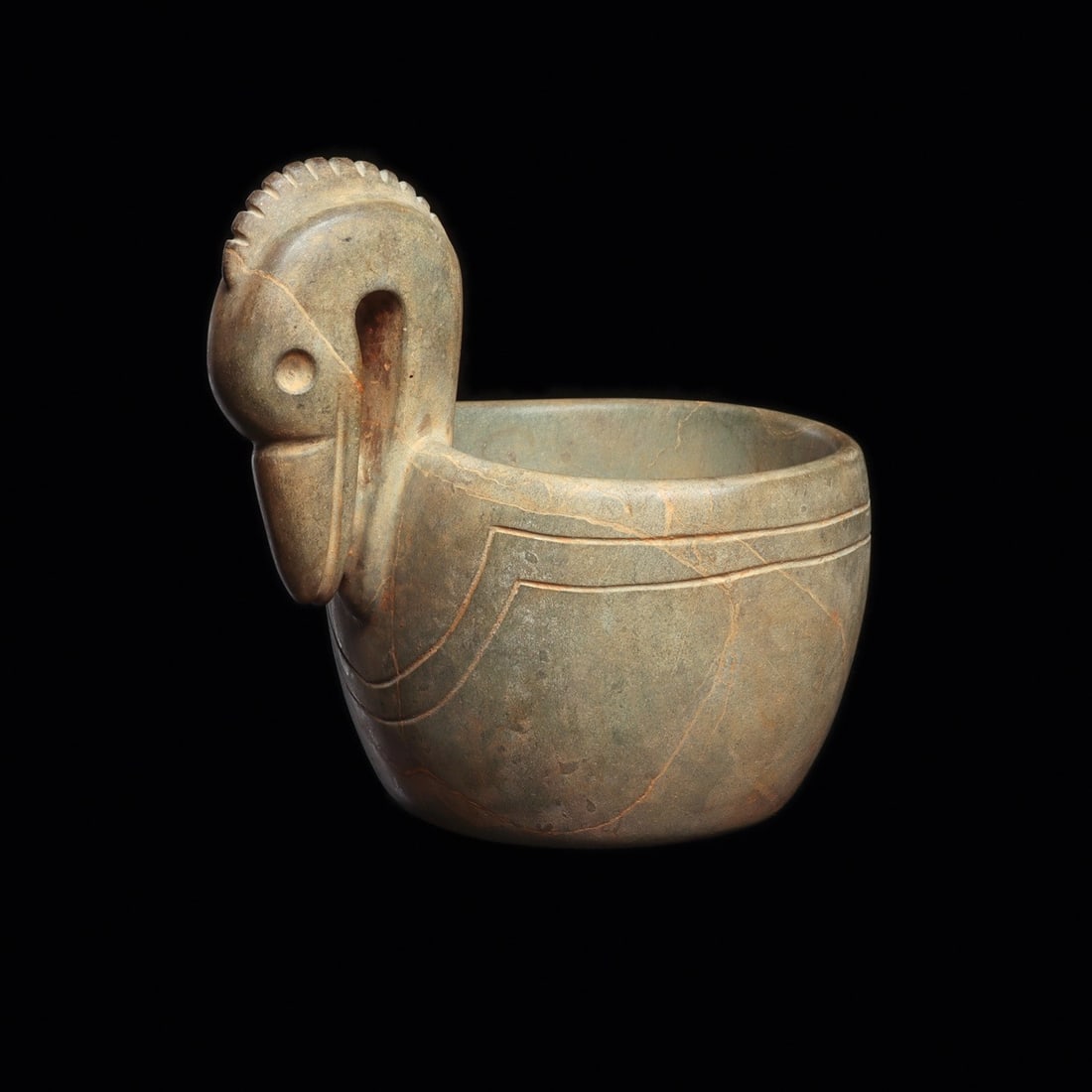 Maya Greenstone Bowl with Crested Waterbird Head Handle: Pre-Columbian, Mesoamerica, Maya, ca. 500–800 CE. A bowl carved from bluish-green stone, its rim rising at one side into the head and neck of a long-billed waterbird. The sculptor cut a raised, 