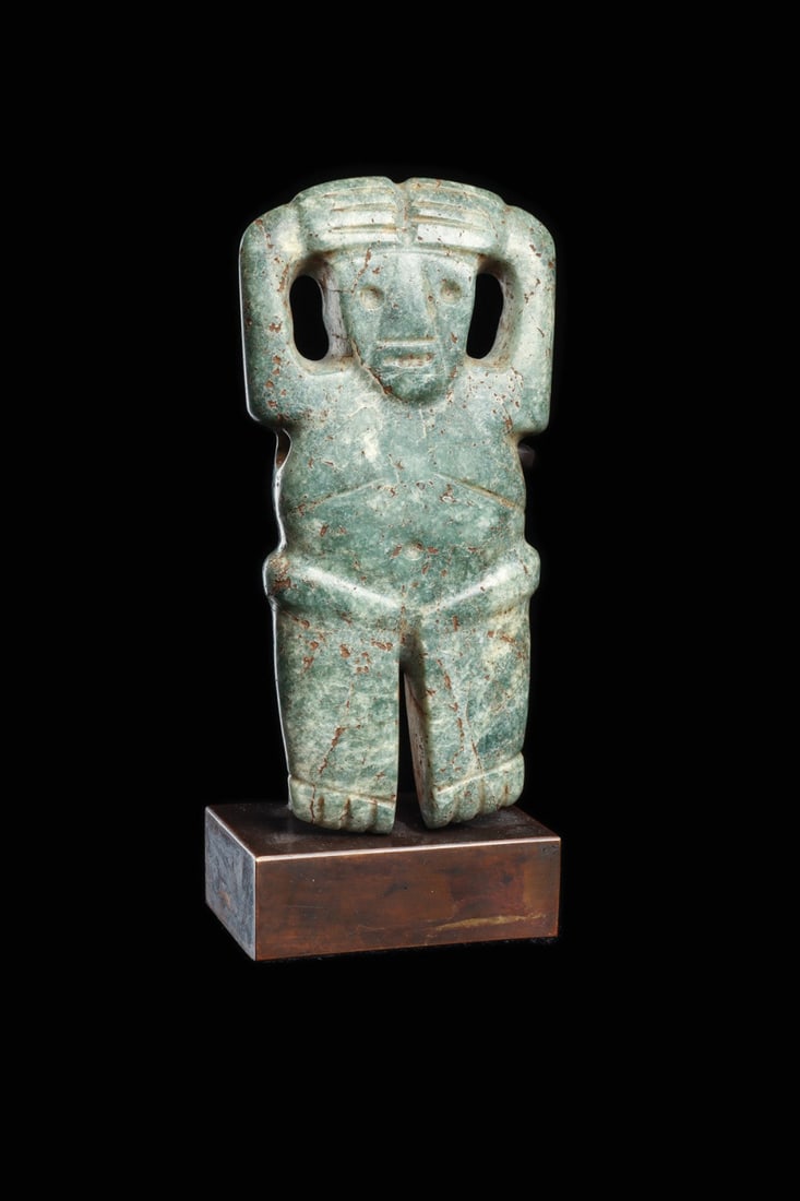 Costa Rican Jade Standing Anthropomorphic Pendant with Raised Arms: Pre-Columbian, Costa Rica, ca. 500–1000 CE. A standing figure carved from mottled blue-green and cream jade, arms lifted so that the delineated fingers rest across the forehead in an arresting, 