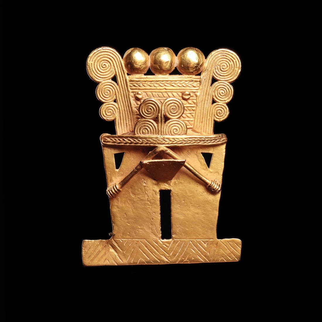 Uraba Gold Mushroom Deity Pendant with Spiral Headdress: Pre-Columbian, Colombia, Uraba, ca. 500–1500 CE. A heavy cast gold pendant reducing the human body to bold geometry: a semiabstract mushroom deity, angular and frontal, crowned by a multispiral 