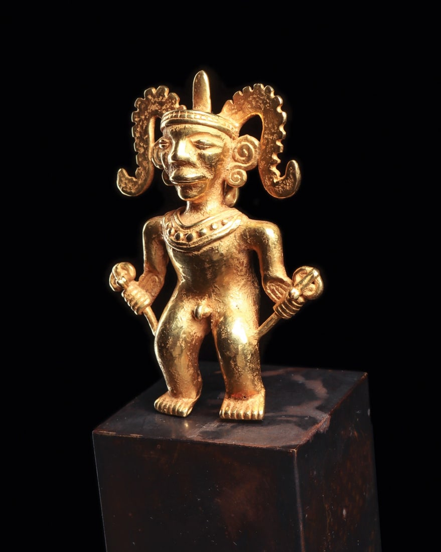 Diquis Gold Dignitary Pendant with Scepters and Plumed Headdress: Pre-Columbian, Costa Rica / Panama, Diquis or Chiriqui, ca. 1000–1250 CE. A cast gold dignitary stands frontally, a scepter gripped in each fist, their shafts terminating in stylized head finial