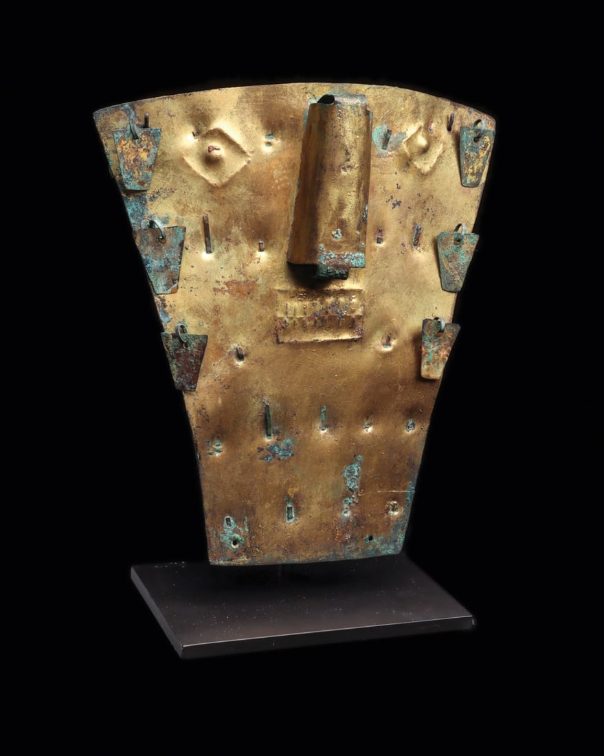 Moche Gilded Sheet Funerary Mask with Danglers, Loma Negra: Pre-Columbian, Peru, Early Moche, Loma Negra, ca. 500–100 BCE. A gilded sheet-metal face hammered into a broad trapezoidal plaque, its features raised from behind: lozenge eyes with domed pupils