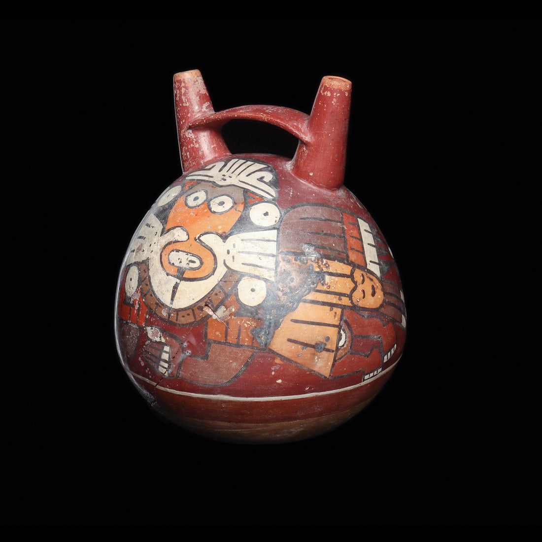 Nazca Double Spout Vessel with Mythical Beings and Trophy Heads: Pre-Columbian, Peru, Nazca, ca. 100–600 CE. A globular ceramic vessel rising to twin tapered spouts joined by a flat strap bridge, its burnished surface painted in slip polychromes of red, orang